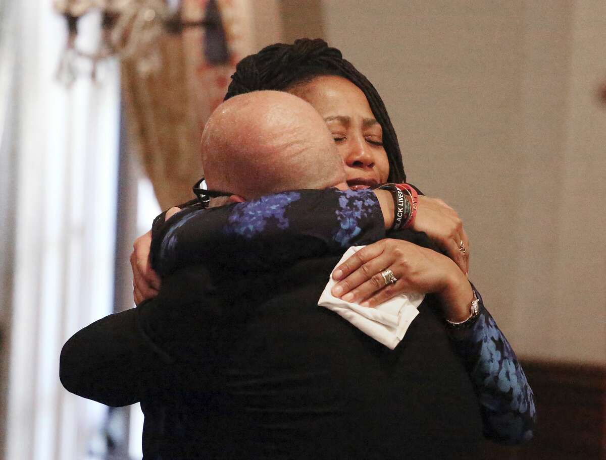 Oakland City Councilwoman Lynette McElhaney, the mother of Victor McElhaney, 21, a University of Southern California student killed Sunday, March 10, 2019, during an attempted robbery, is embraced after talking about her son during a news conference on the USC campus in Los Angeles Tuesday, March 12, 2019. She described her son's life from a high-risk pregnancy through an early talent for drumming to his start of classes at USC. "Victor's not a homicide number or statistic, or just another black boy gunned down in South Central Los Angeles," she said. "I want you all to know that Victor came into the world a drummer. He was drumming from the moment he could sit up." Detectives were searching for three or four male suspects (AP Photo/Reed Saxon)