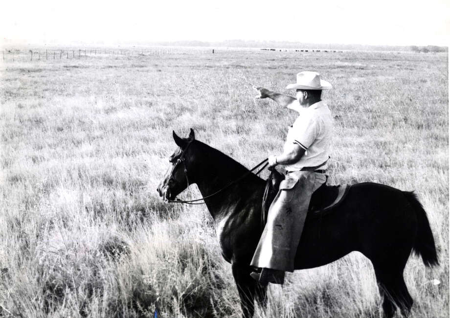 In this 1961 file photo, H.H. Smith points out the future site for the Johnson Space Center, which as the time was America’s largest space lab. Smith was manager of the Clear Lake ranch, owned by Humble Oil Company, which gave the 1,000-acre site to Rice University on condition it be used for a space center. Rice donated the land to the National Aeronautics and Space Administration. (NASA)