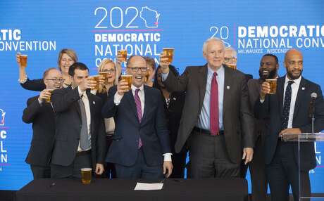 Democratic National Committee chairman Tom Perez, center, hoists a celebratory beer with Milwaukee Mayor Tom Barrett, right, and Milwaukee Bucks senior vice president Alex Lasry, left, following the official announcement March 11, 2019 that Milwaukee will host the 2020 Democratic National Convention. Perez chose Milwaukee over Houston and Miami.
