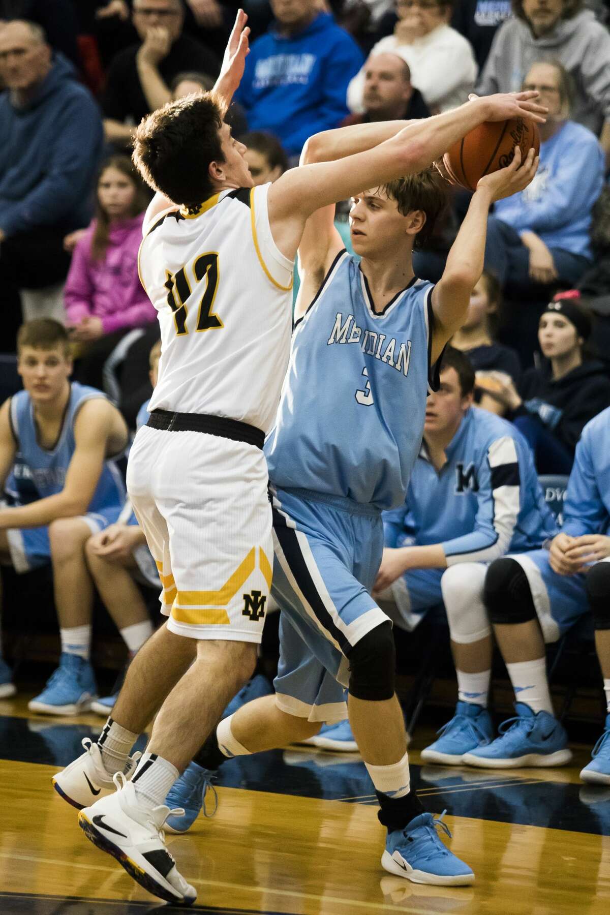 Meridian's Lucas Lueder looks for a teammate to pass to during the Mustangs' 56-61 Division 3 state quarterfinals loss to Iron Mountain on Tuesday, March 12, 2019 at Petoskey High School. (Katy Kildee/kkildee@mdn.net)