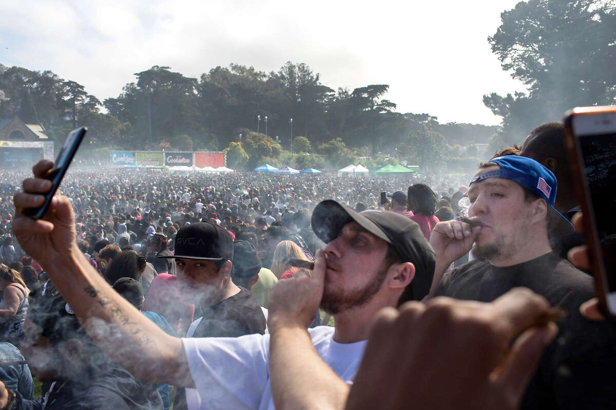 People take their selfies as they light up their joints after 4:20pm passed at the Hippie Hill 4/20 celebration in Golden Gate Park on Friday, April 20, 2018. San Francisco Calif. This is the first year when recreational marijuana use is legal in California.