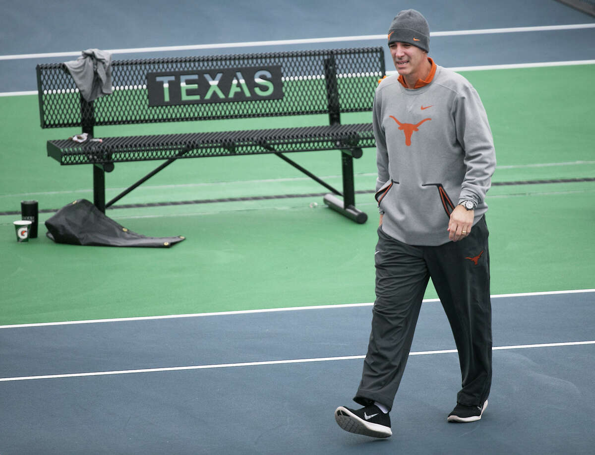 In this January 2018 photo, Texas men’s tennis coach Michael Center surveys the courts before the matches with UTSA, in Austin, Texas. Center is among a few people in the state charged in a scheme that involved wealthy parents bribing college coaches and others to gain admissions for their children at top schools, federal prosecutors said Tuesday, March 12, 2019. (Ralph Barrera/Austin American-Statesman via AP)