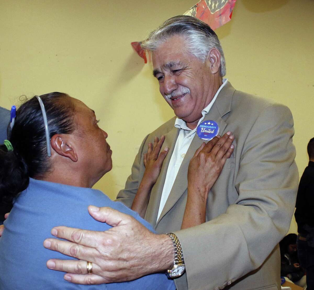 Democrat Ray Lopez is greeted by Norma Witherspoon at Tuesday night’s watch party at Lopez’s campaign headquarters on Bandera Road. Lopez defeated Republican Fred Rangel in the runoff for Texas House District 125.