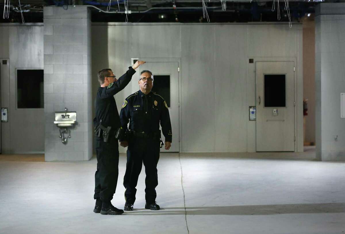 Bexar County Capt. Keith Klepac, left, and Bexar County Deputy Chief R.A. Vela, talk during a tour of the new Bexar County Justice Intake and Assessment Center which has been built next to the Bexar County Jail, on Friday, April 13, 2018.