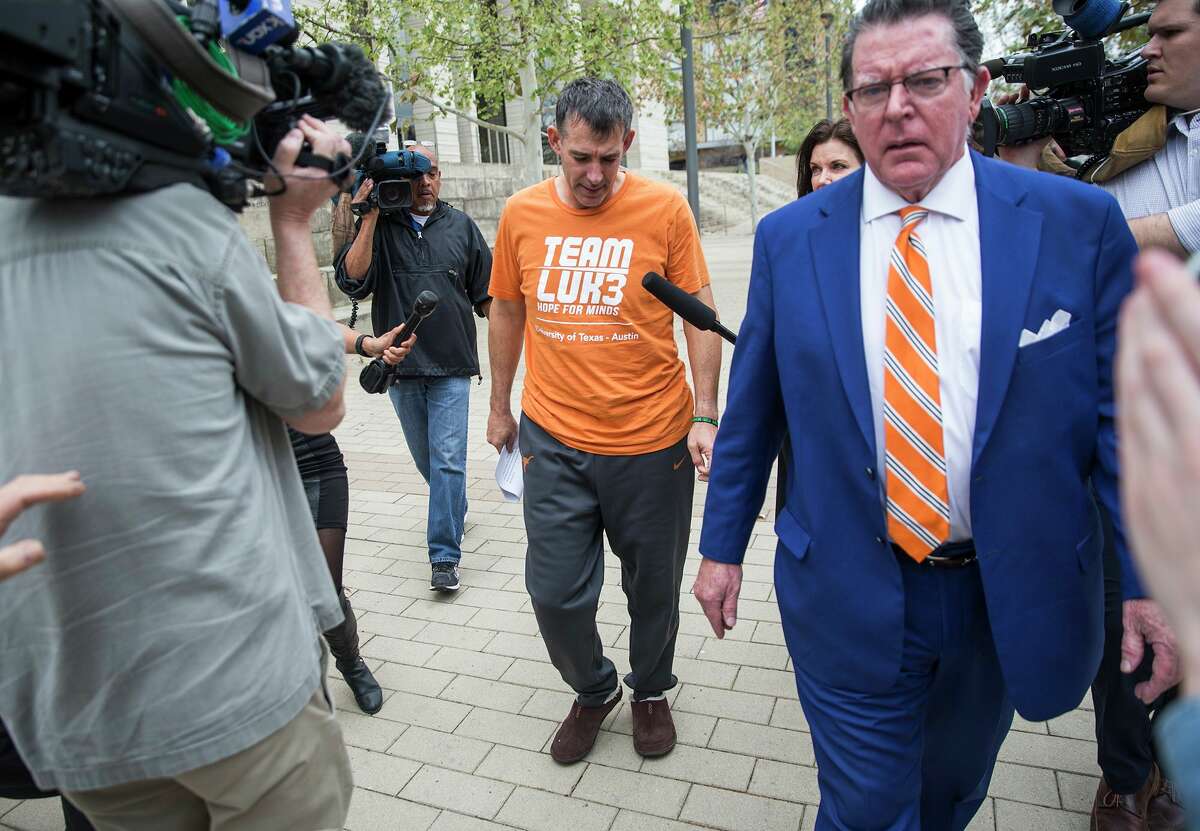 Texas men's tennis coach Michael Center walks with Defense lawyer Dan Cogdell away from the United States Federal Courthouse in Austin, Texas, Tuesday, March 12, 2019. Michael Center was placed on administrative leave after being charged by federal authorities that he allegedly accepted a $100,000 bribe in 2015 to help a student's admission. RICARDO B. BRAZZIELL/AMERICAN-STATESMAN]