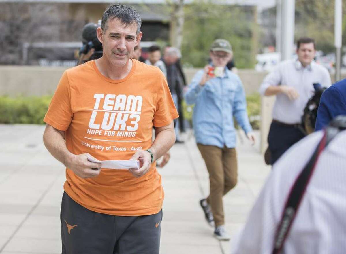 Texas men’s tennis coach Michael Center walks with defense lawyer Dan Cogdell away from the U.S. Federal Courthouse in Austin, Texas, Tuesday, March 12, 2019. Michael Center was placed on administrative leave after being charged by federal authorities that he accepted a $100,000 bribe in 2015 to help a student's admission process.