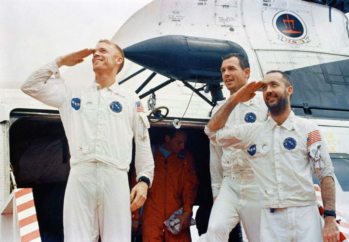 (13 March 1969) --- The Apollo 9 crewmen arrive aboard the USS Guadalcanal as they step from a helicopter to receive a red-carpet welcome. Two of the crewmen salute the crowd of newsmen, Navy and NASA personnel gathered to greet them. From left are astronauts Russell L. Schweickart, David R. Scott, and James A. McDivitt.