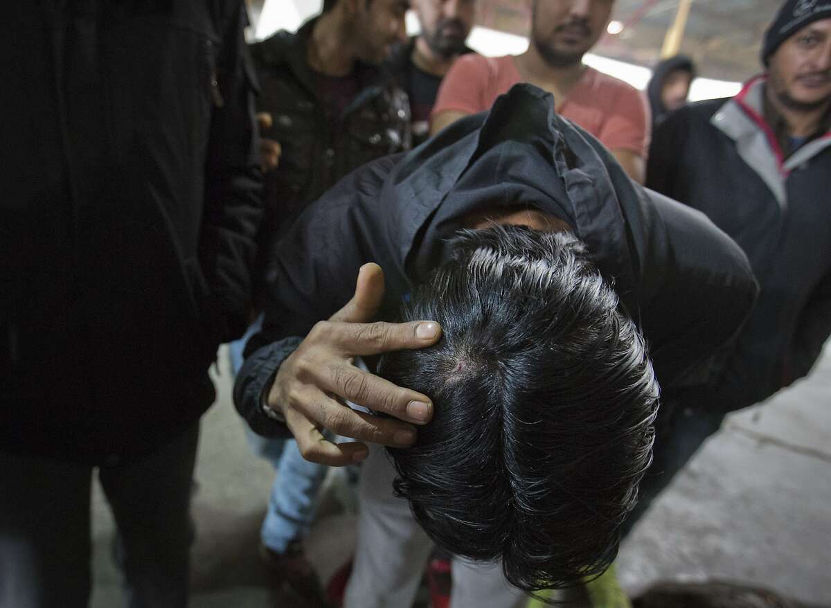 A migrant who claims he was beaten by Croatian police while attempting to cross the border to Croatia shows his injury at a factory hall turned migrants facility in Bihac, Bosnia-Herzegovina, Wednesday, March 13, 2019. Rights group Amnesty International has accused European Union states of complacency in the "systematic, unlawful and frequently violent pushbacks" by Croatian border guards of thousands of asylum-seekers to squalid and unsafe refugee camps in Bosnia. (AP Photo/Darko Bandic)
