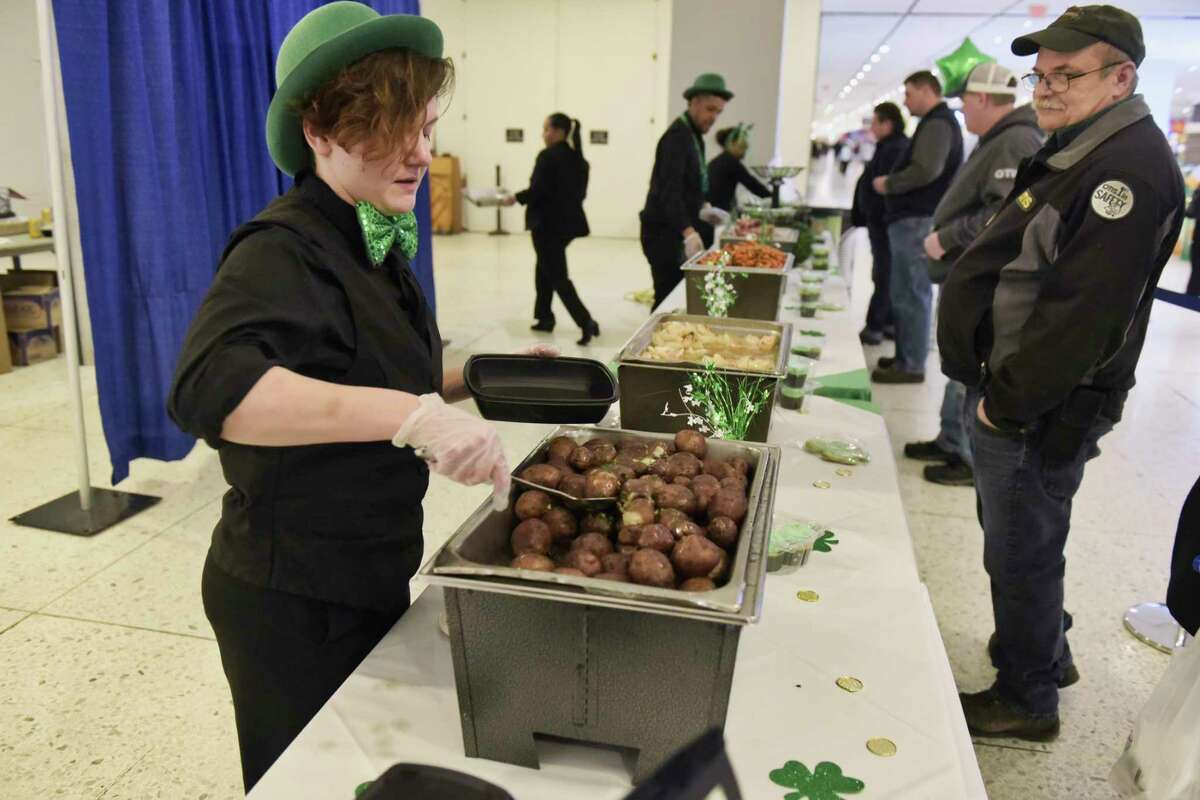 Jamie Shields, with Mazzone Hospitality, serves up a traditional corned beef and cabbage lunch at the St. Patrick's Day Celebration on the concourse level of the Empire State Plaza on Wednesday, March 13, 2019, in Albany, N.Y. (Paul Buckowski/Times Union)