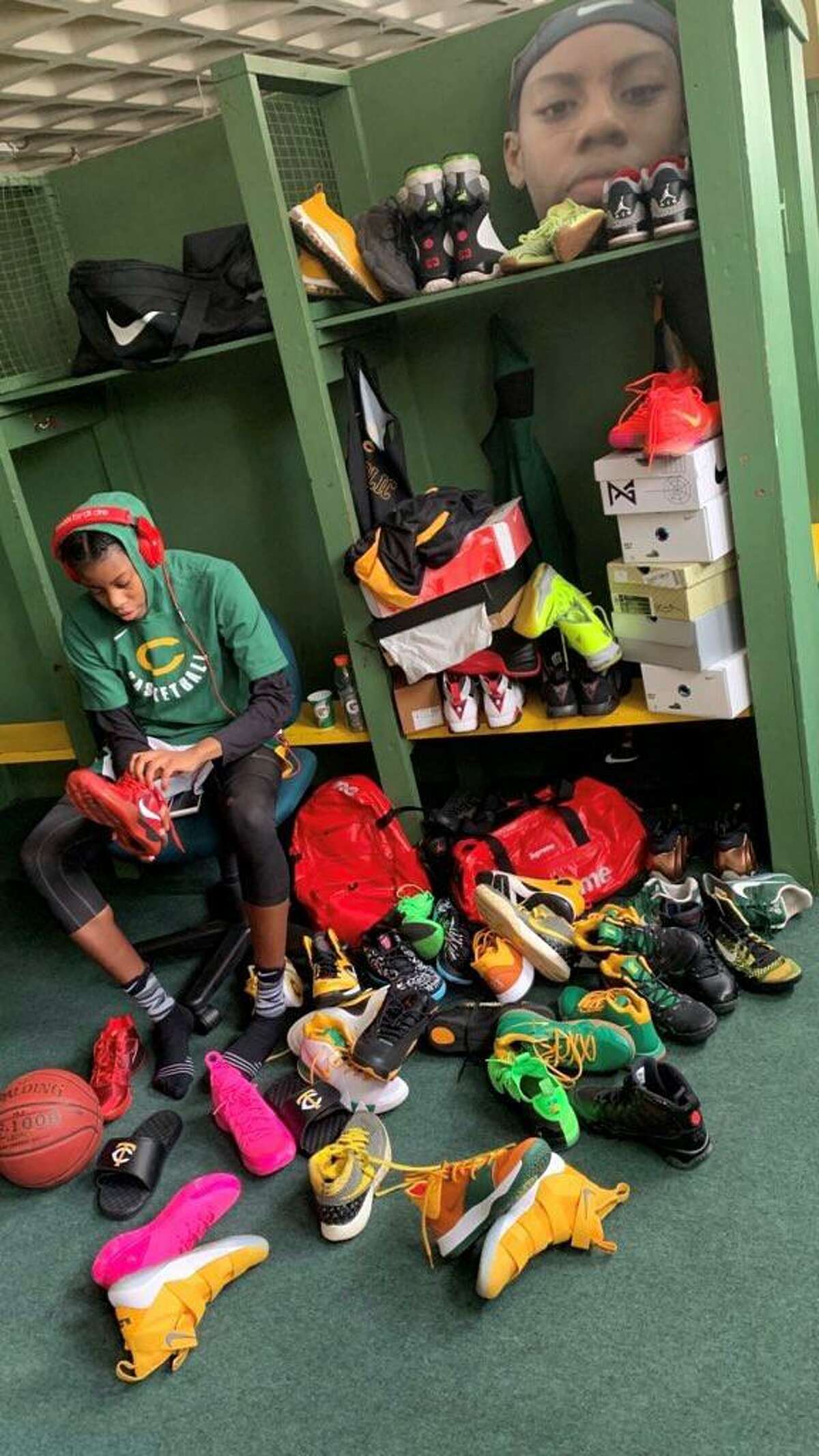 Trinity Catholic star Iyanna Lops at her locker with her sneaker collection.