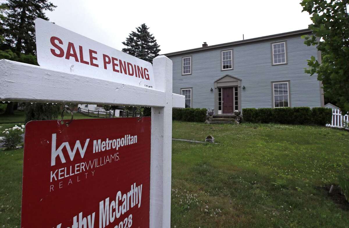 FILE- This June 15, 2018, file photo shows a "sale pending" sign is posted outside a home in East Derry, N.H. On Wednesday, Feb. 27, 2019, the National Association of Realtors releases its January report on pending home sales, which are seen as a barometer of future purchases. (AP Photo/Charles Krupa, File)