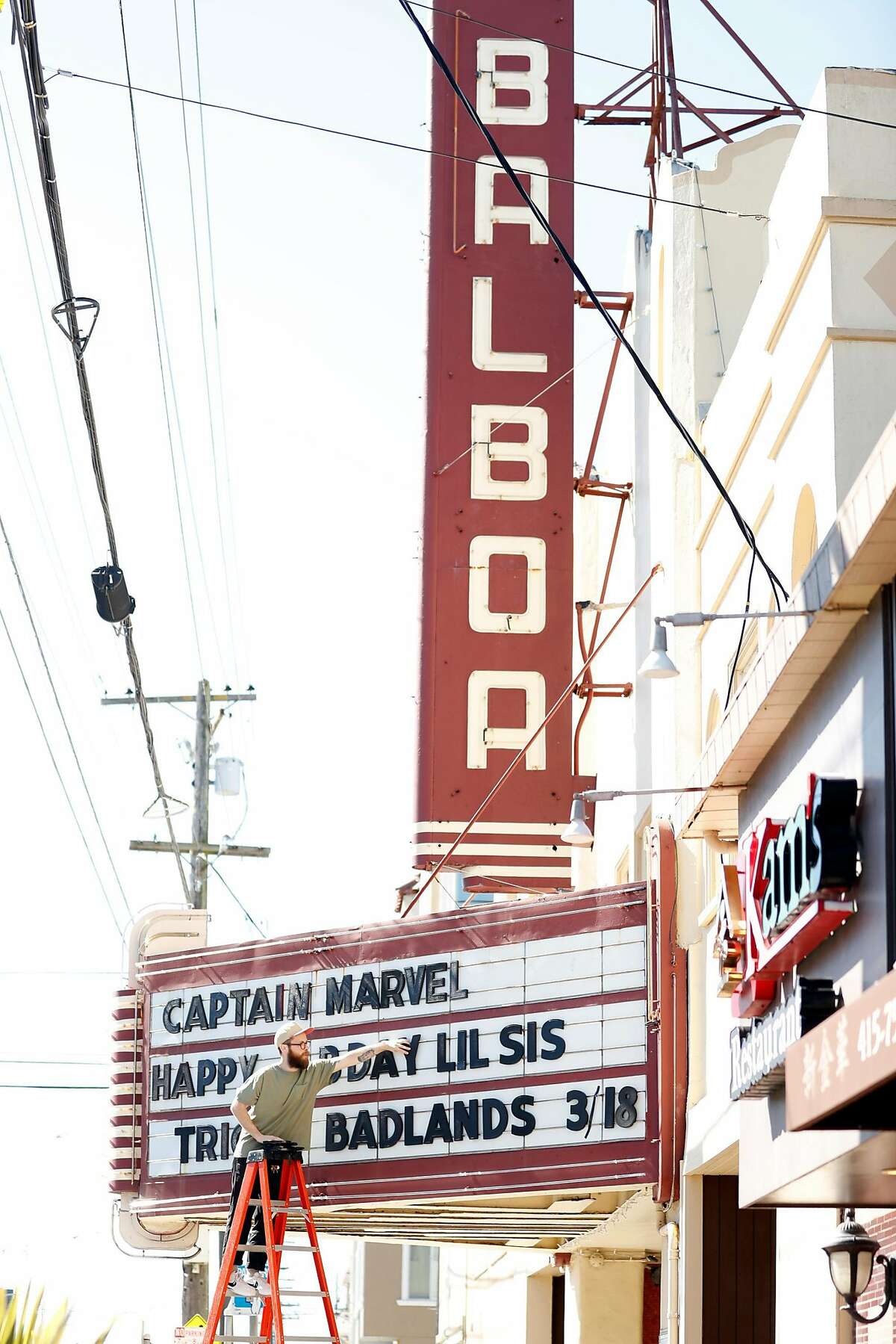 Ryan Andersen changes the letters on the marquee at Balboa Theater in San Francisco, Calif., on Monday, March 11, 2019.