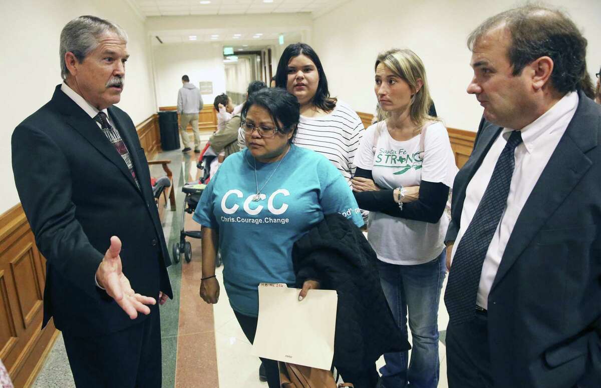 Santa Fe families converse with Sen. Larry Taylor, R-Friendswood, in the hallway after they appear Wednesday in Austin to voice their opposition to HB256 by Rep. Joseph Moody which would reduce length of sentences for offenders under 18 years of age on March 13, 2019.
