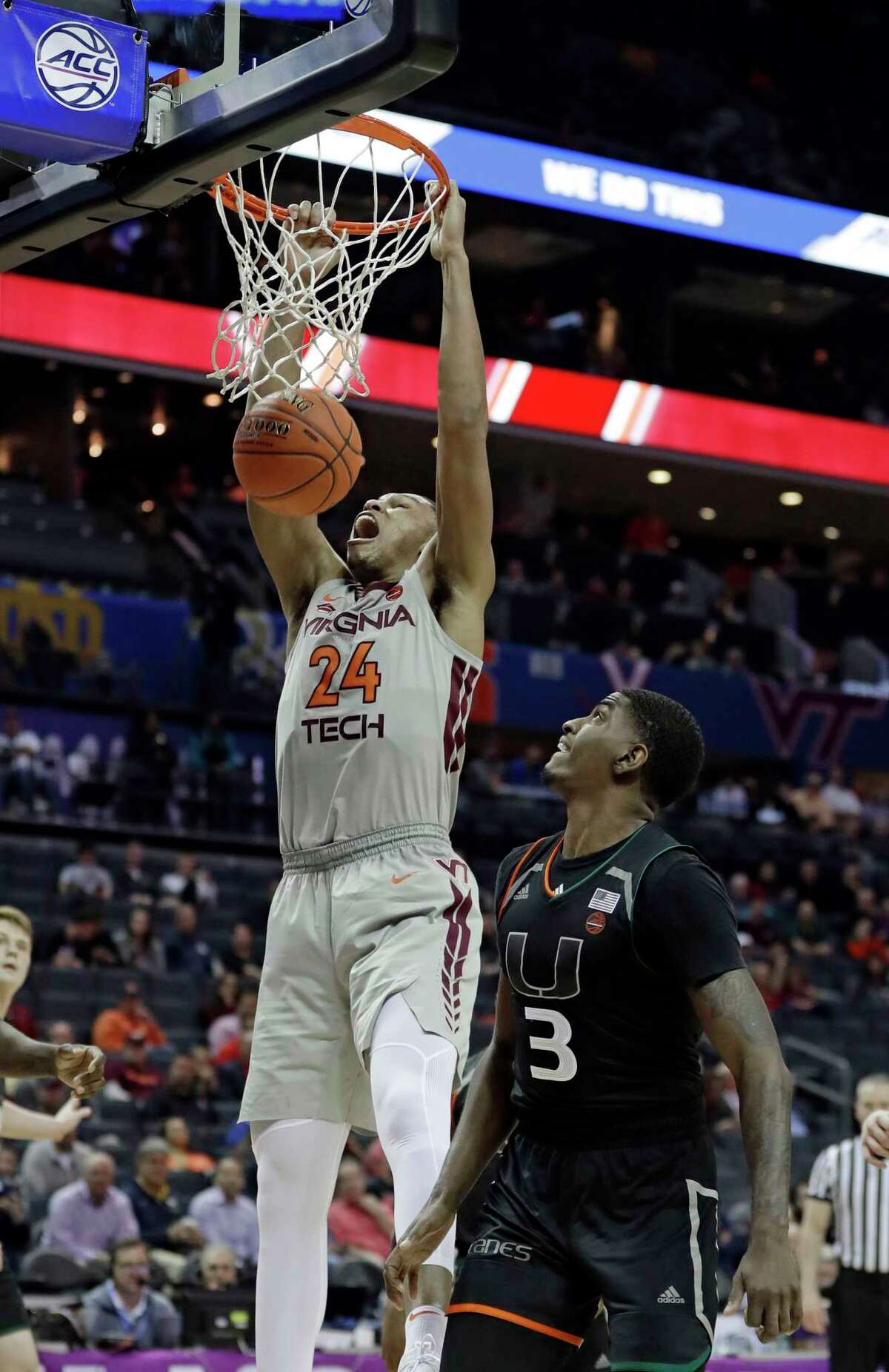 Virginia Tech's Kerry Blackshear Jr. (24) dunks past Miami's Anthony Lawrence II (3) during the second half of an NCAA college basketball game in the Atlantic Coast Conference tournament in Charlotte, N.C., Wednesday, March 13, 2019. (AP Photo/Nell Redmond)