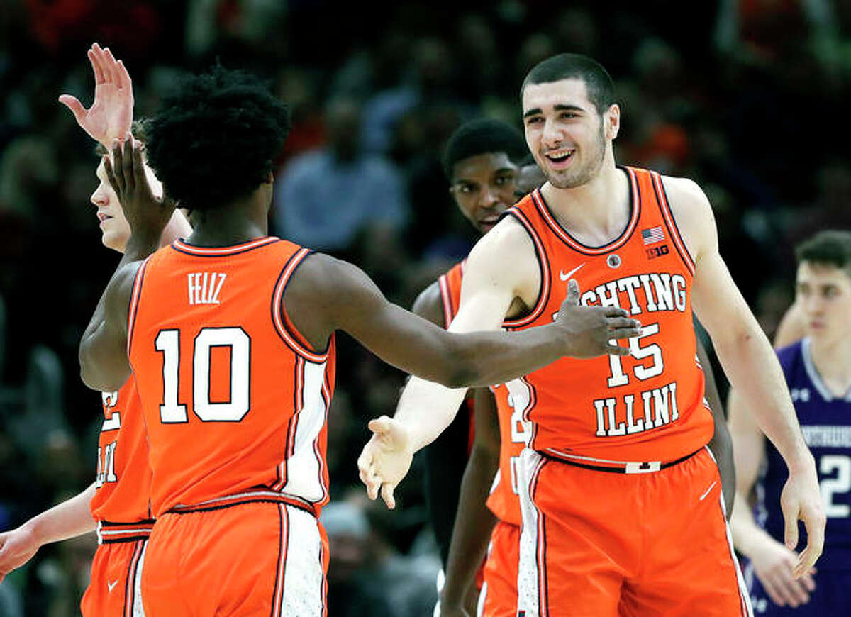 Illinois forward Giorgi Bezhanishvili, right, smiles as he celebrates with guard Andres Feliz after scoring a basket against Northwestern in Wednesday night’s game in the first round of the Big Ten Conference Tournament in Chicago.