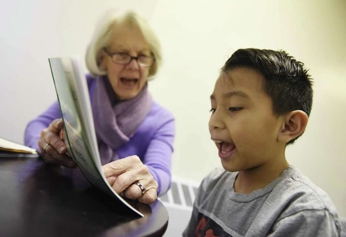 Volunteer Pat Young, the former Headmistress at Stanwich School, tutors Greenwich's Charles Cajas, 8, at Family Centers' Family First in Education program at the YMCA Early Learning Center in the Chickahominy section of Greenwich, Conn. Tuesday, Jan. 29, 2019. The program attempts to bridge the socio-economic opportunity gap by offering an after school tutoring service and home visits to ensure parents get involved with their children's educations.