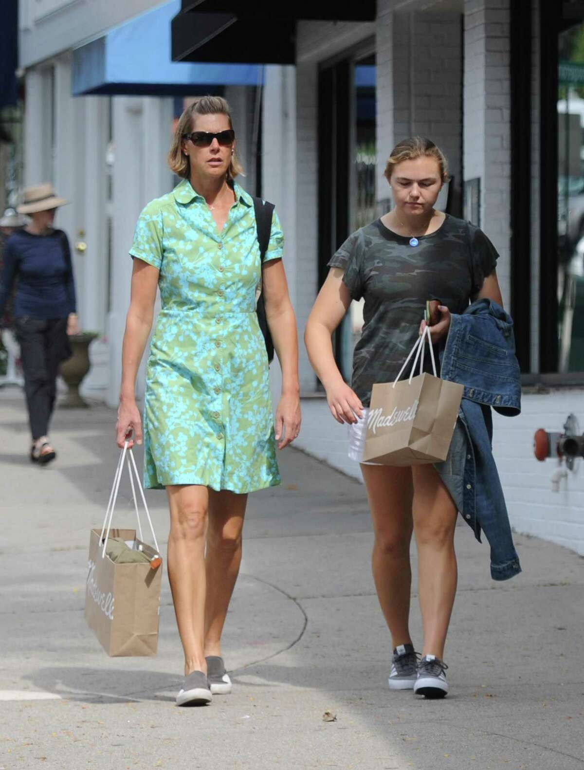 Women carry their shopping items in paper bags down Greenwich Avenue in Greenwich, Conn. Wednesday, Sept. 19, 2018. Stores and customers have had mixed reactions since the plastic bag ban was implemented in Greenwich on Wednesday Sept. 12.