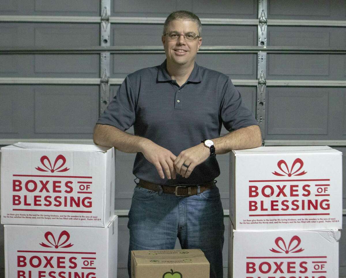 Aaron Clendenen, Elevate 61 operator, poses next to a collection of food he has gathered for donation Wednesday, March 13, 2019 at his home in Magnolia. Elvate 61 is a anti-human traficking program based out of Magnolia.