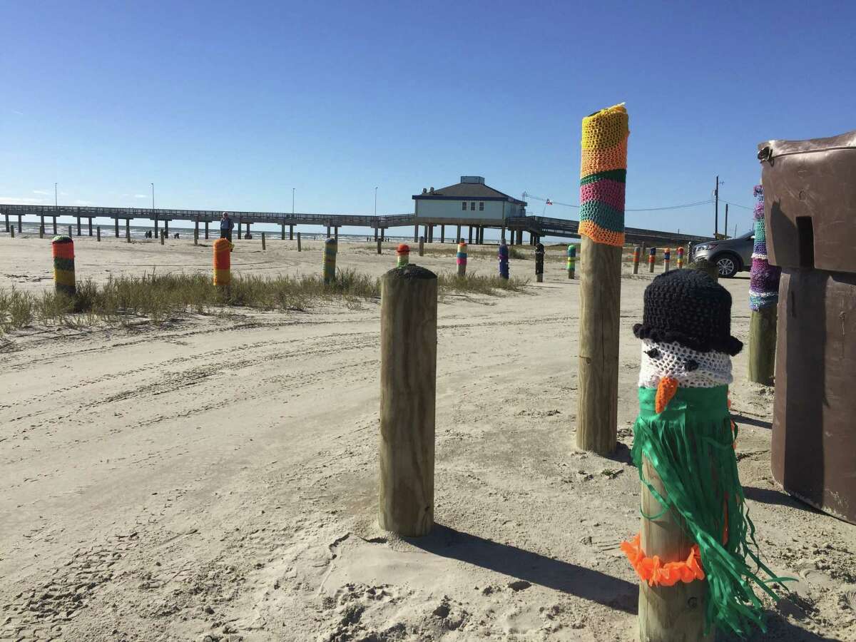 Diana Vondra, a crochet enthusiast and winter Texan, designs fanciful caps for the wooden sentinels that guard beach traffic on Mustang Island.