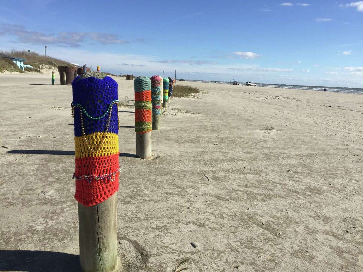 Diana Vondra, a crochet enthusiast and winter Texan, designs fanciful caps for the wooden sentinels that guard beach traffic on Mustang Island.