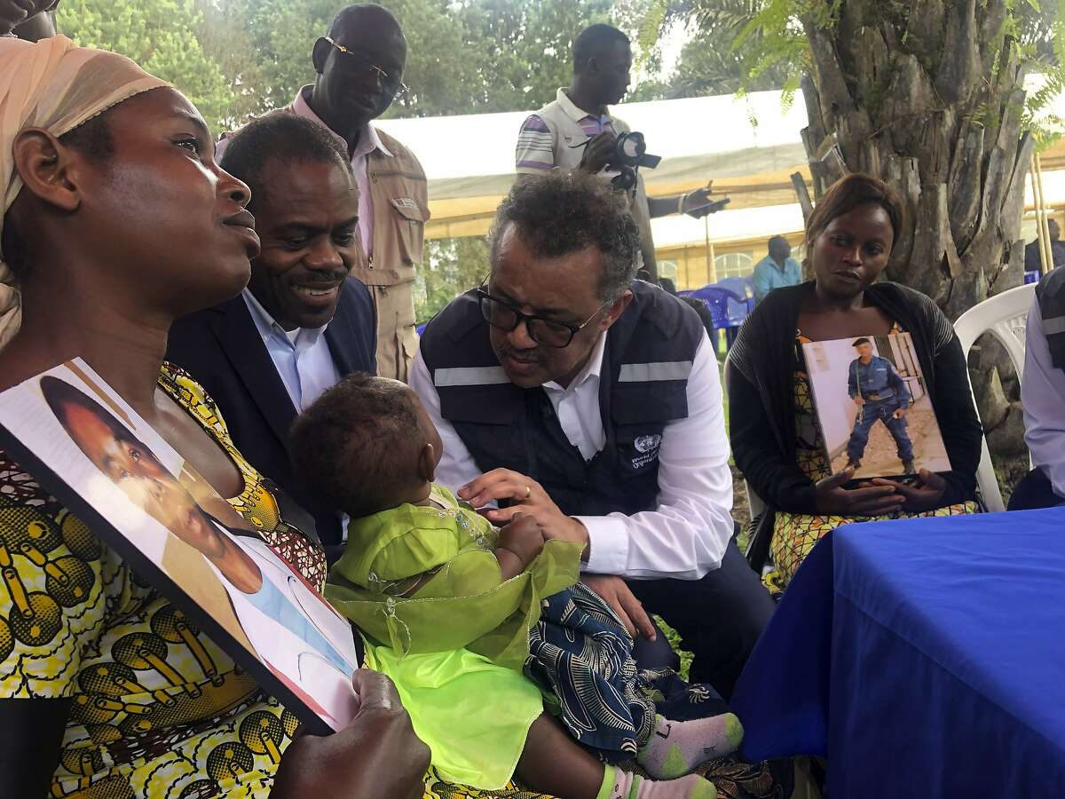 WHO Director-General, Dr Tedros Adhanom Ghebreyesus and DRC Ministry of Health, Dr Oly meet with widows who lost their husbands to conflict during a visit to an Ebola treatment centre in Butembo, in the Democratic Republic of the Congo, Saturday March 9, 2019. Armed assailants again attacked an Ebola treatment center in the heart of eastern Congo's deadly outbreak on Saturday, with one police officer killed and health workers injured. (Dalia Lourenco/WHO via AP)