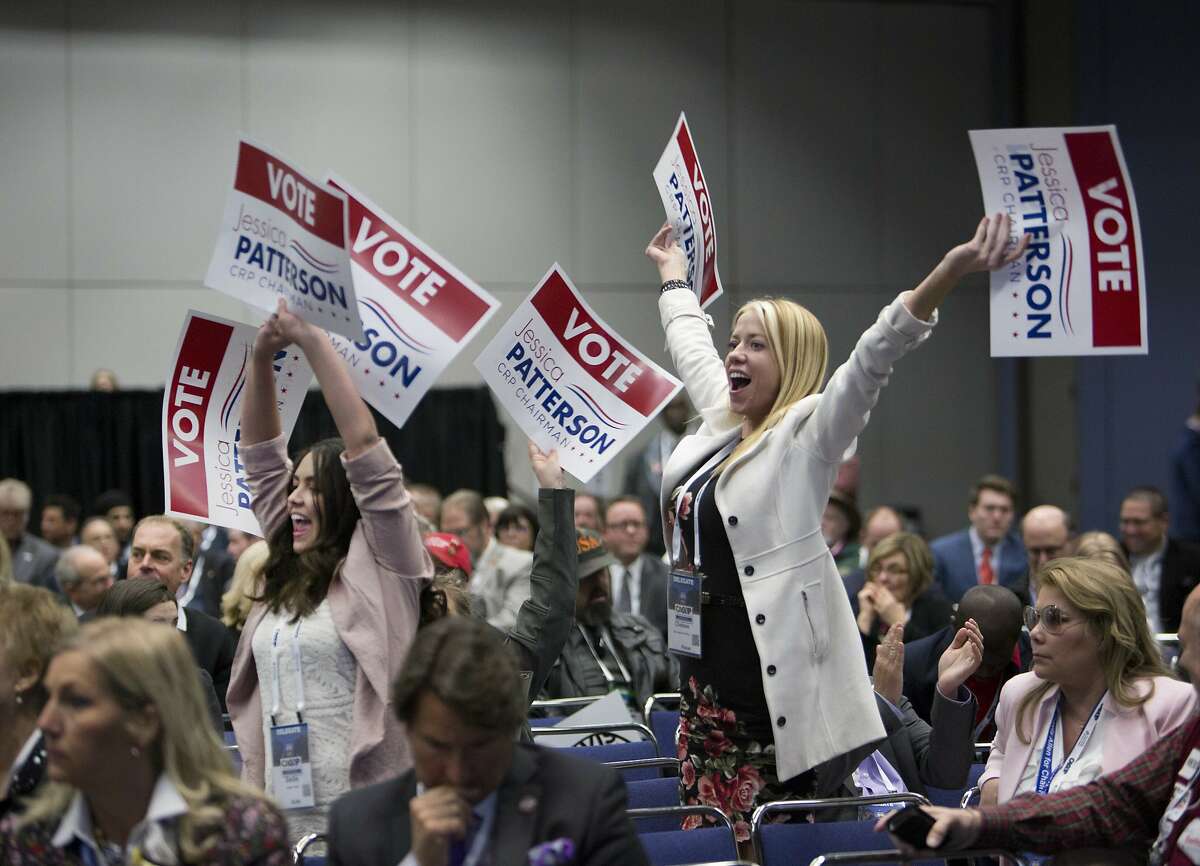 Supporters of candidate for chair of the California Republican Party Jessica Patterson wave their signs during the party convention in Sacramento, Calif., Saturday, Feb. 23, 2019. (AP Photo/Steve Yeater)