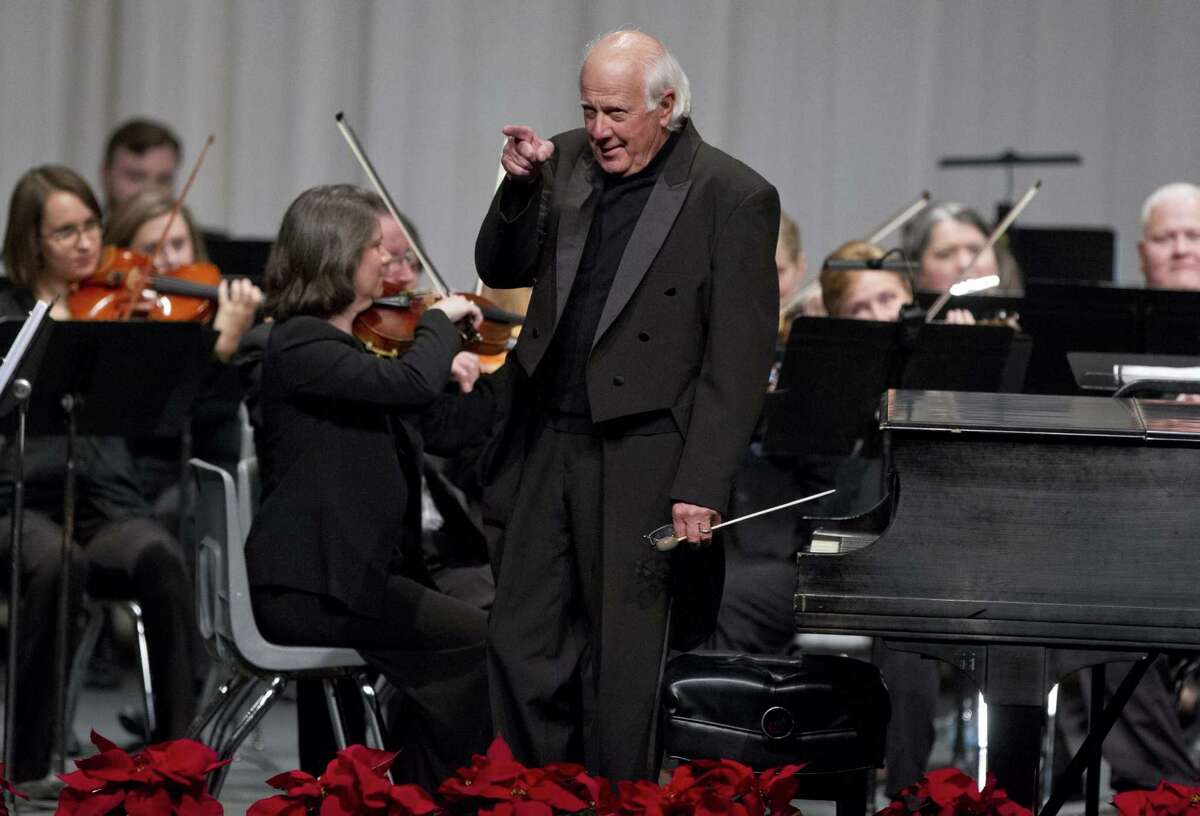 Conroe Symphony Orchestra conductor Don Hutson jokes with the audience before a concert at Conroe High School Saturday.