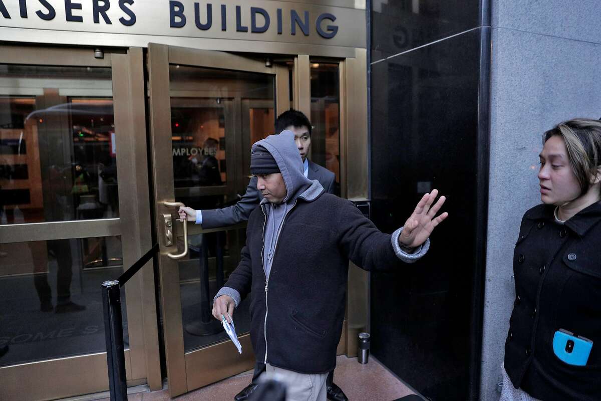 Hay Hov waves to supporters as he and his wife Catherine Depooter-Hov enter the U.S. Immigration and Customs Enforcement offices in San Francisco, Calif., where Hay will to turn himself over to ICE officials on Wednesday, March 13, 2019. Hov was told to turn himself in after being in the U.S. since he was 6 years old, brought by his parents, but he lost his green card at 19 when he was convicted of a crime. The Trump administration is now cracking down on Cambodians and other Southeast Asian undocumented immigrants.