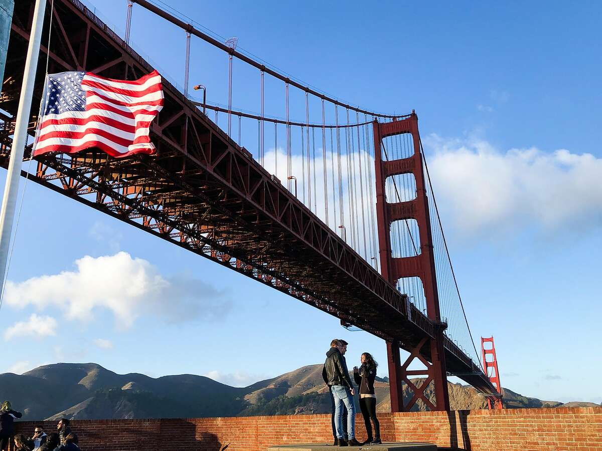 Visitors walk on the roof of Fort Point on Saturday, Dec. 1, 2018, in San Francisco, CA. The Golden Gate Bridge towers above Fort Point.
