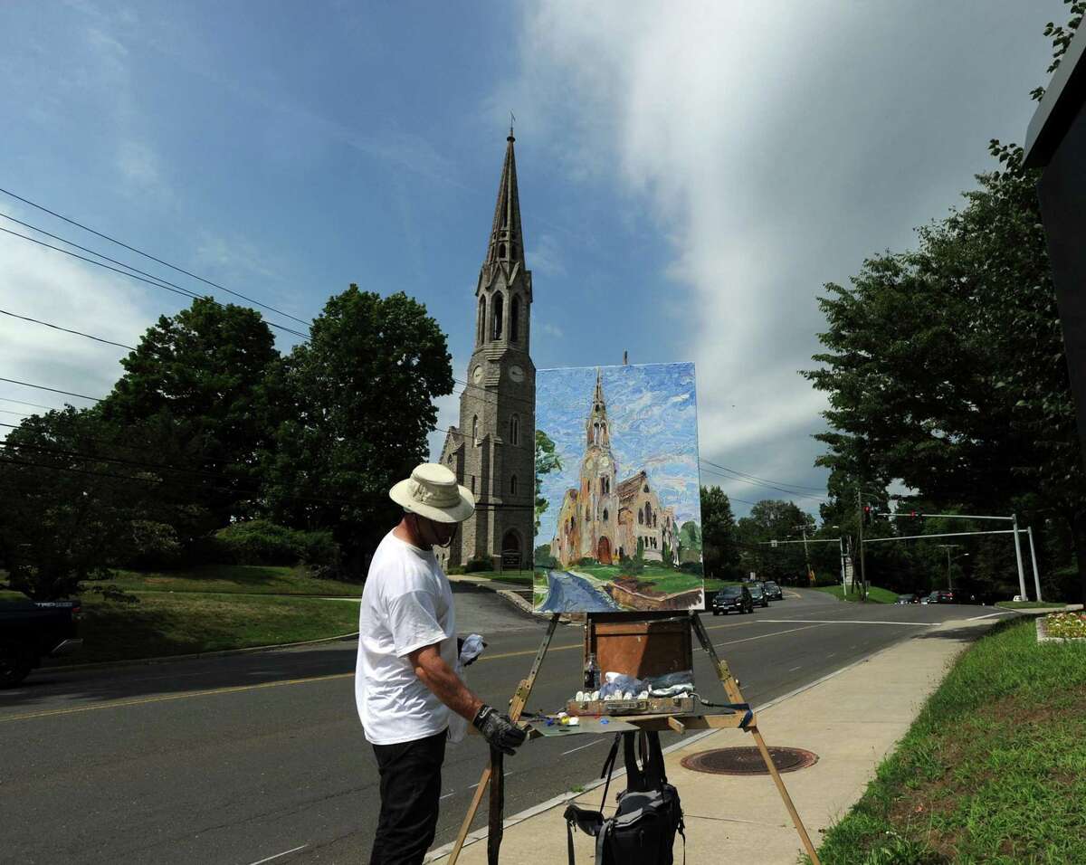 Jim Chillington of Newtown paints the Second Congregational Church in Greenwich, Conn., Wednesday, July 13, 2016. Some residents fear the classic look of Greenwich, embodied by the church, is being overtaken by soulless suburban design.