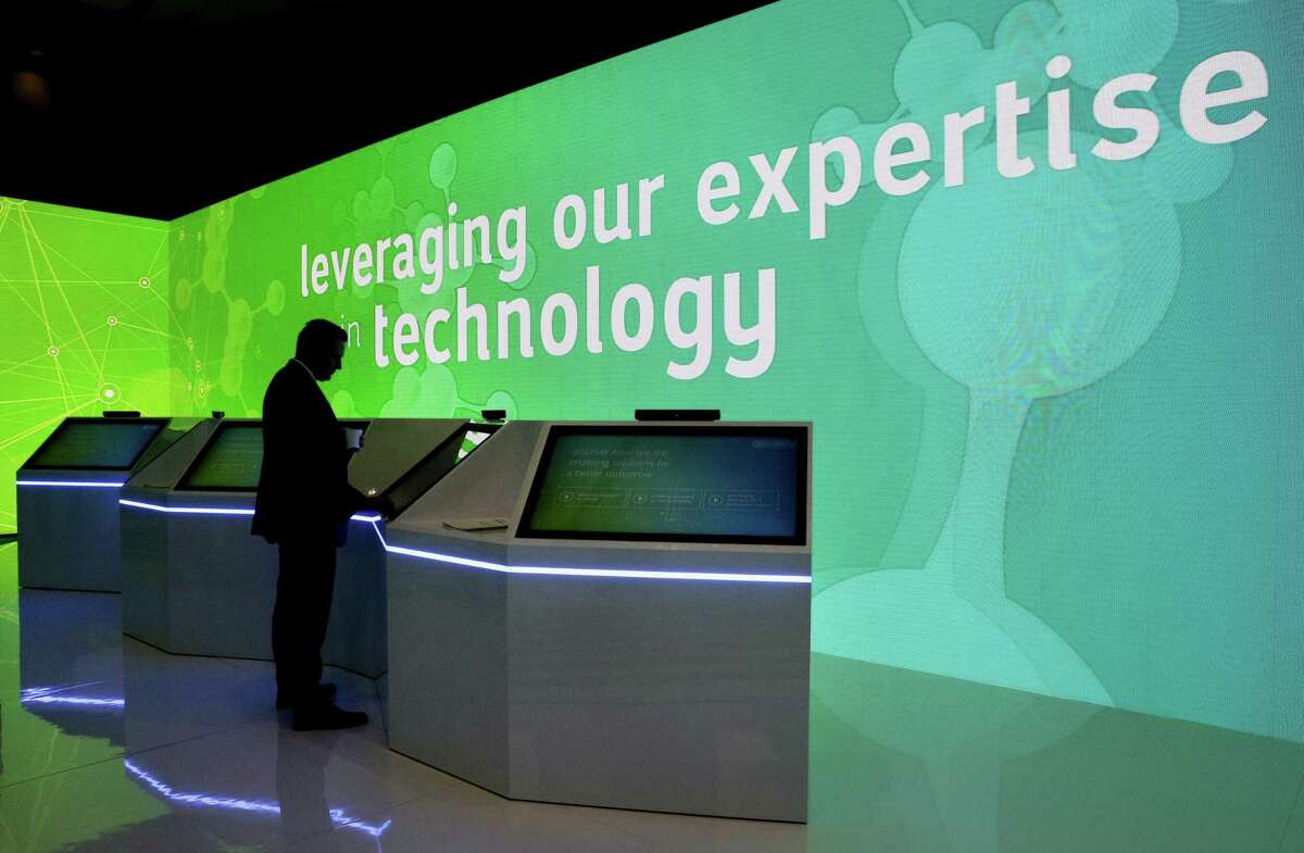 A conference attendant uses the touch screen displays and next to moving lit walls highlighting technologies in the Saudi Aramco room during the second day of CERAWeek by IHS Markit at the George R. Brown Convention Center Tuesday, Mar. 12, 2019 in Houston, TX.
