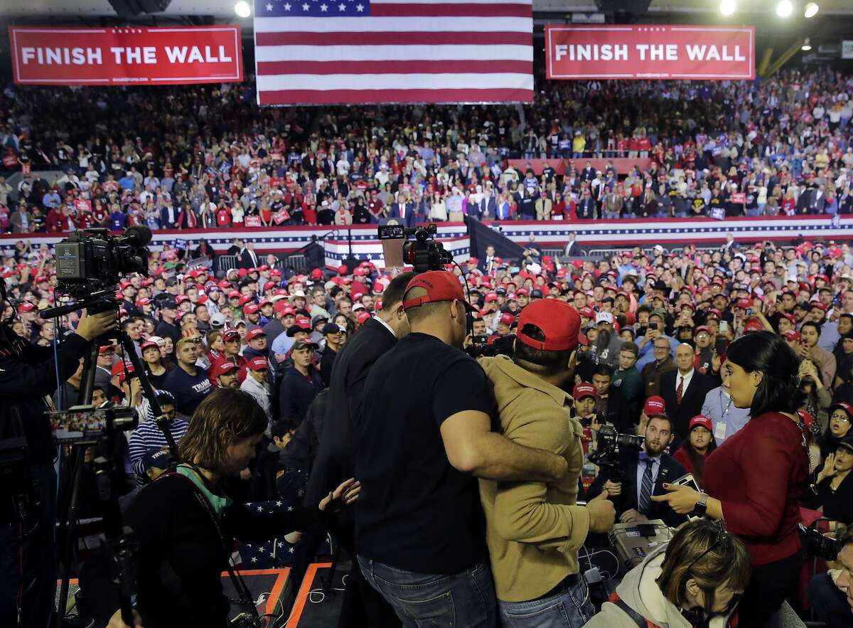 A man is restrained after he began shoving members of the media during a rally for President Donald Trump at the El Paso County Coliseum, Monday, Feb. 11, 2019, in El Paso, Texas.