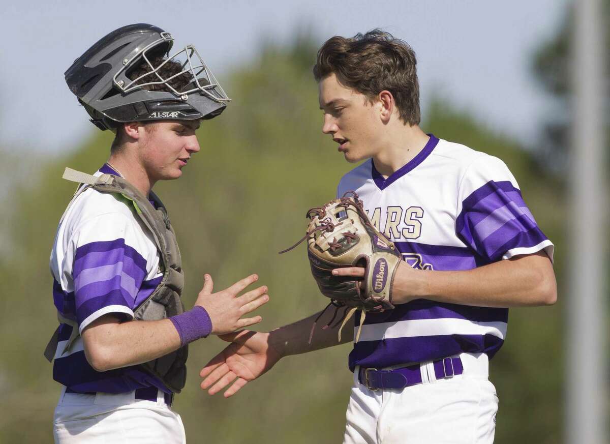 Montgomery starting pitcher Charlie Taylor (14) gets high-five from catcher Grant Brown (9).