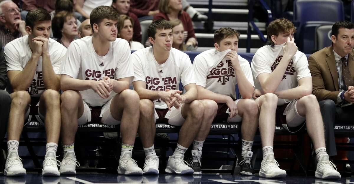 Texas A&M players watch from the bench in the final minutes of an NCAA college basketball game against Mississippi State at the Southeastern Conference tournament Thursday, March 14, 2019, in Nashville, Tenn. Mississippi State won 80-54. (AP Photo/Mark Humphrey)
