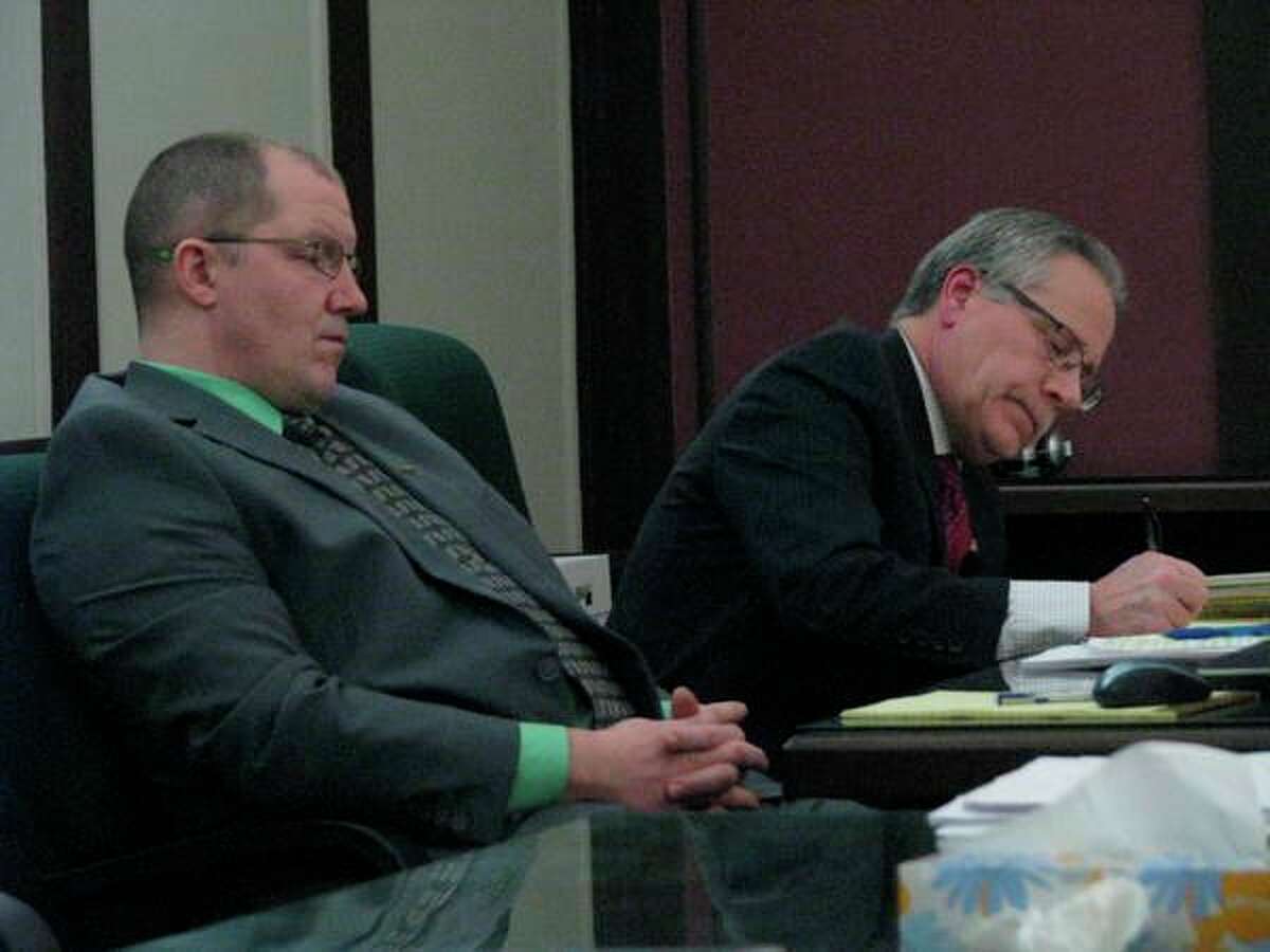 Officer Jeremy Davis of the Midland Police Department, left, and Midland County Prosecuting Attorney J. Dee Brooks listen to defense attorney Dan Duke's closing argument during the trial of Joel Brandon Wallace on March 14, 2019 in the 42nd Circuit Court.