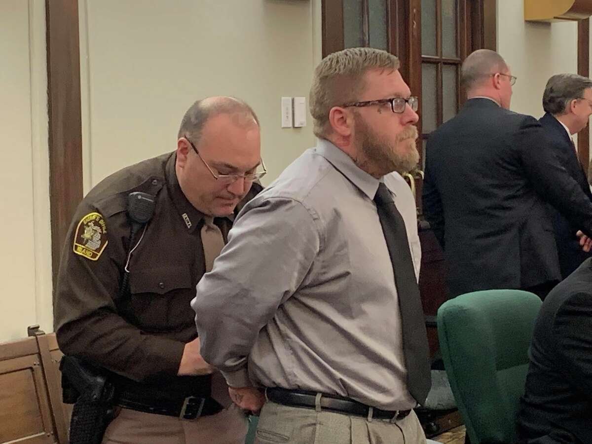Joel Brandon Wallace is handcuffed by a court officer after being found guilty of five criminal charges, including the first degree premeditated murder of his great-aunt Victoria Kilbourne, on March 15, 2019 in the 42nd Circuit Court.