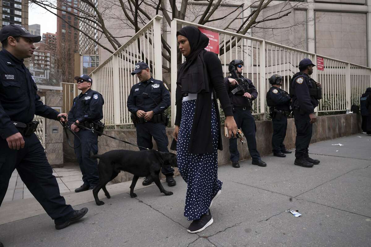 A woman arrives for service at the Islamic Cultural Center of New York under increased police security following the shooting in New Zealand, Friday, March 15, 2019, in New York. (AP Photo/Mark Lennihan)