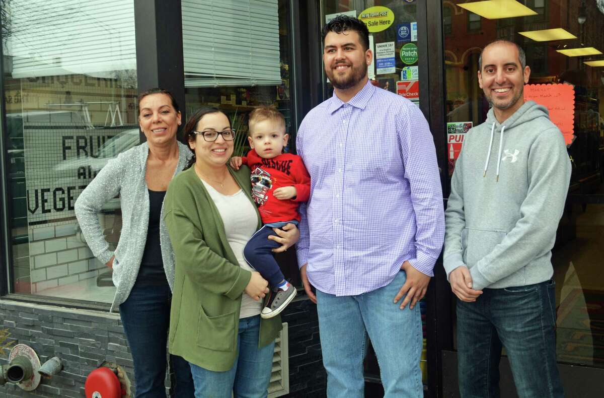 Josh Morris, second from right, is the new owner of Public Market, which has been at 480 Main St., Middletown, since 1915. Shown, from left are Maria Passacantando, Amelia Passacantando, Giovanni Passacantando, Morris and Middletown Police Officer John Passacantando. Morris purchased the shop Friday and will reopen its doors Monday morning.