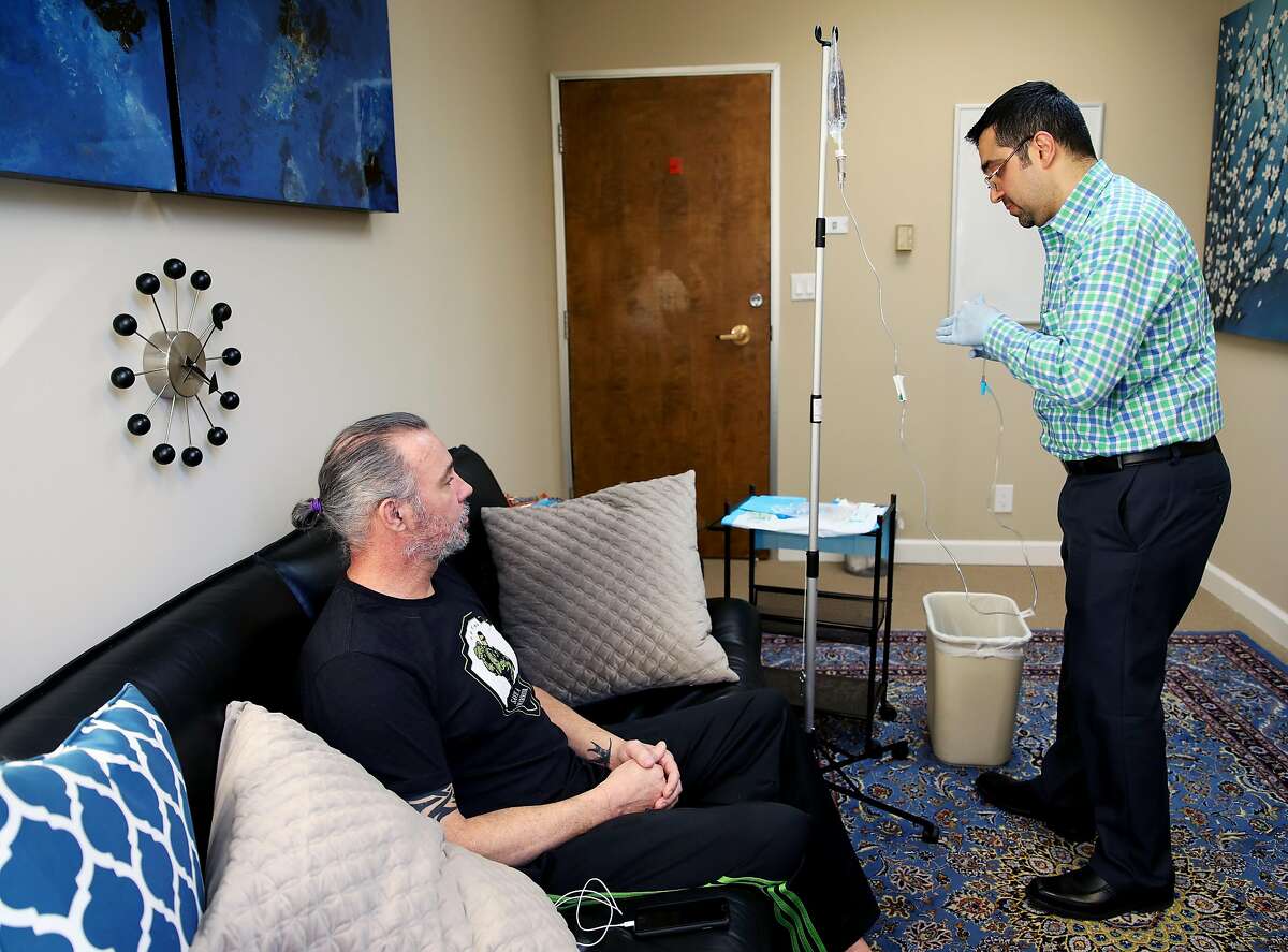Dr. M. Rameen "Dr. G" Ghorieshi treats patient Joel W., 50, during a visit to Palo Alto Mind Body in Palo Alto, Calif., on Wednesday, March 13, 2019. Ghorieshi is preparing to give his patient a ketamine IV at the clinic. A new ketamine-based nasal spray treatment was approved by the FDA last week to treat severe depression. "I think Dr. G offers a alternative to opioids and pysch medicines and stuff. And I think that the opportunity was presented to me and I took it and I'm real appreciative that Dr. G allowed me to come to his office and participate in the program," said W, who served in the Navy for nearly seven years. "I think that anybody that has PTS, whether it be through the military, through law enforcement, through traumatic incidents at home, through any traumatic incident, domestic abuse, whatever, I think people could benefit from this. It's an opportunity to take care of yourself so that you can take care of others."
