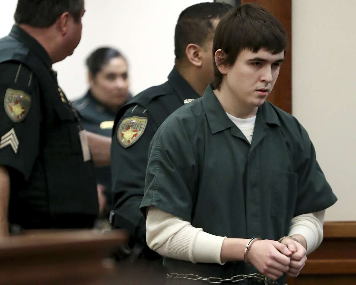 Dimitrios Pagourtzis, the student accused of killing 10 people in a May 18, 2018, shooting at Santa Fe High School, is escorted by Galveston County Sheriff's Office deputies into the jury assembly room for a change of venue hearing at the Galveston County Courthouse in Galveston, Texas on Monday, Feb. 25, 2019. (AP Photo/Jennifer Reynolds, Pool)