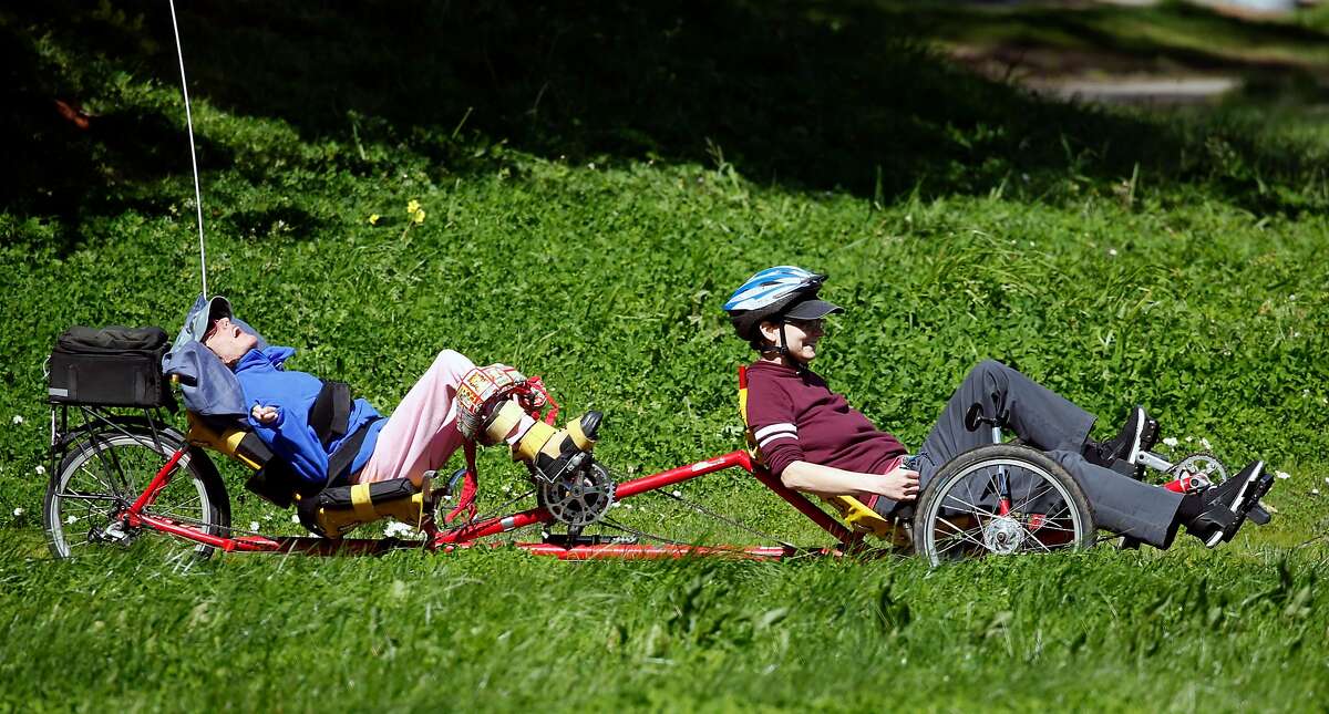 Ames Lefever (right) leads Jackie Donovan in an exercise program for persons with disabilities aboard a tandem recumbant bicycle provided by the BORP Adaptive Cycling Center at Aquatic Park in Berkeley, Calif. on Tuesday, March 12, 2019.