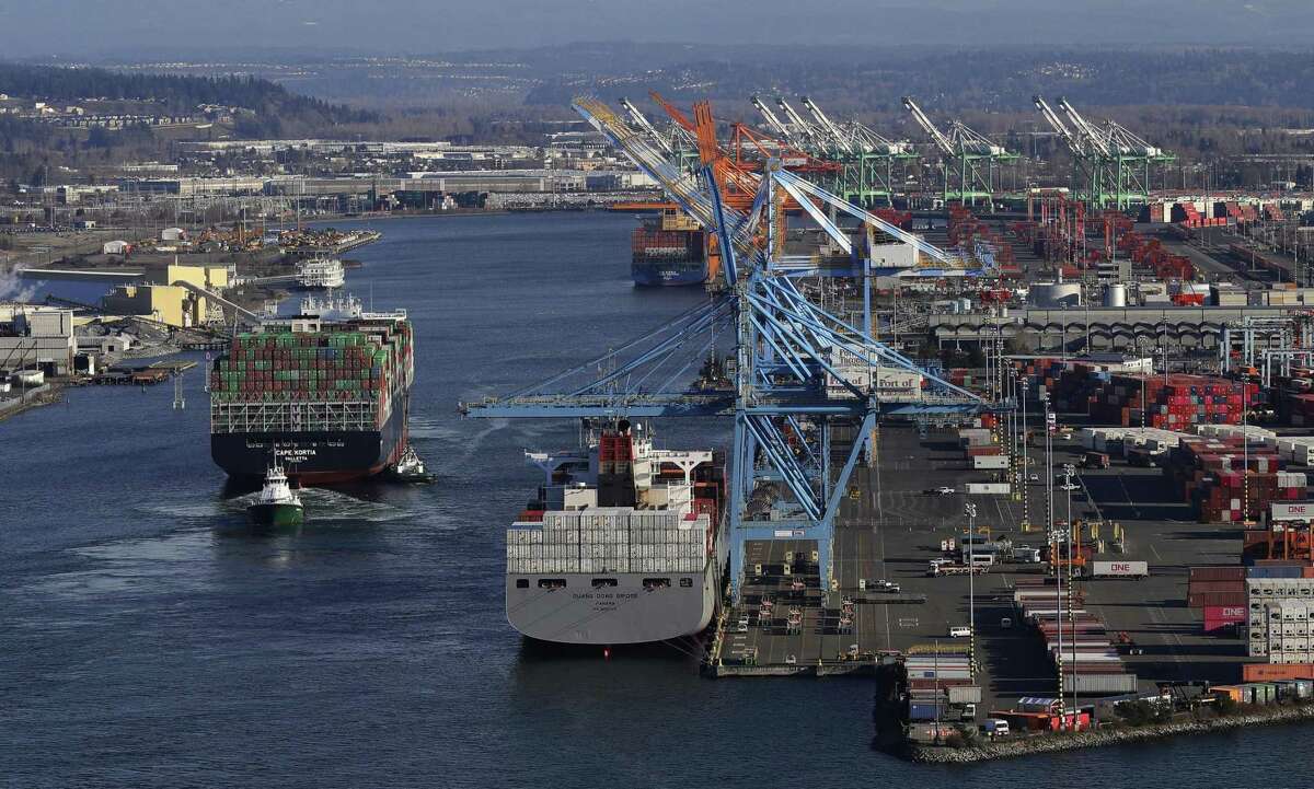 The Cape Kortia container ship, left, heads into the Port of Tacoma in Commencement Bay in Tacoma, Wash., recently. Global trade in which goods cross borders is better than what happens in the absent of that — armies crossing borders.