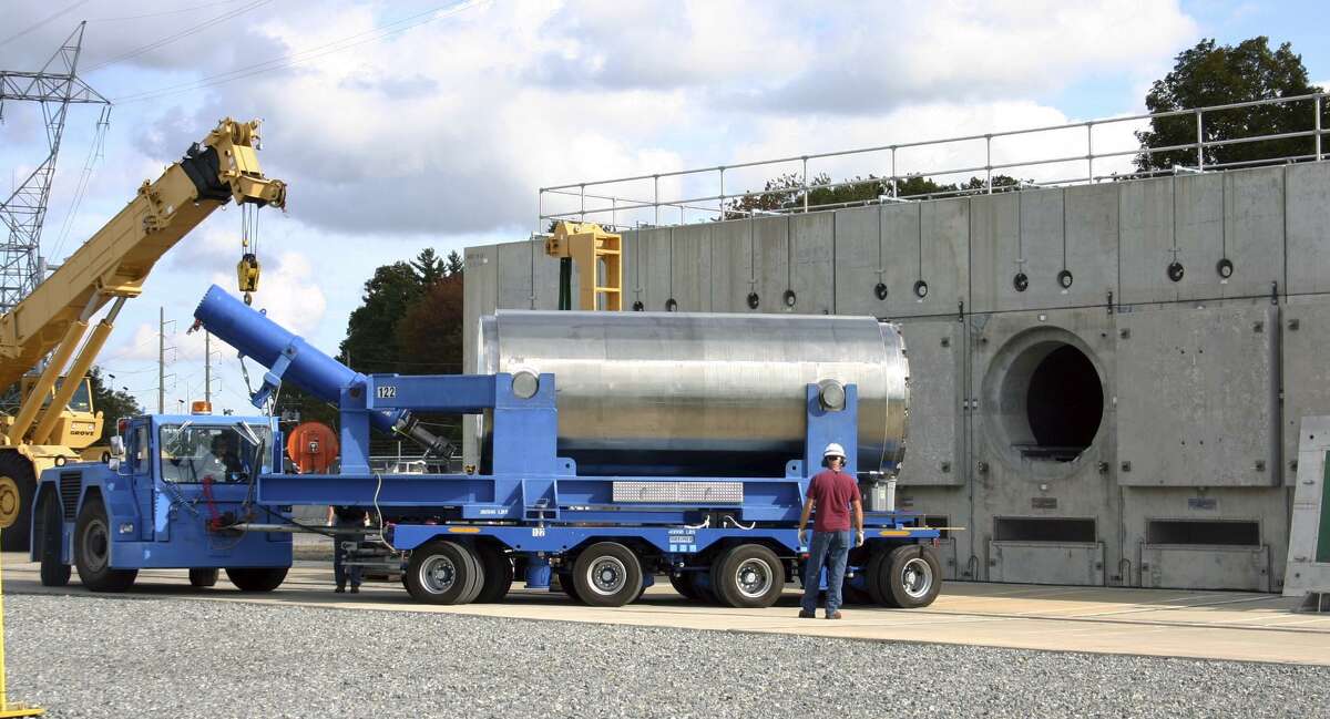 In this Oct. 14, 2010 photo released by Dominion Resources, a trailer holding a spent fuel storage container is maneuvered into position for offloading into a horizontal storage module at the Millstone Power Station in Waterford.