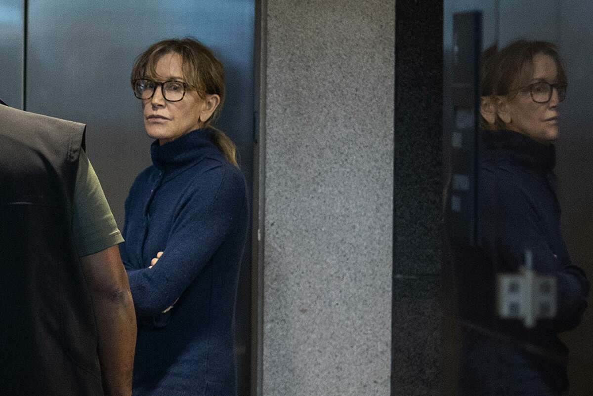 TOPSHOT - Actress Felicity Huffman is seen inside the Edward R. Roybal Federal Building and U.S. Courthouse in Los Angeles, on March 12, 2019. - Two Hollywood actresses including Oscar-nominated "Desperate Housewives" star Felicity Huffman are among 50 people indicted in a nationwide university admissions scam, court records unsealed in Boston on March 12, 2019 showed. The accused, who also include chief executives, allegedly cheated to get their children into elite schools, including Yale, Stanford, Georgetown and the University of Southern California, federal prosecutors said.Huffman, 56, and Lori Loughlin, 54, who starred in "Full House," are charged with conspiracy to commit mail fraud and honest services mail fraud. A federal judge set bond at $250,000 for Felicity Huffman after she was charged in a massive college admissions cheating scandal. (Photo by DAVID MCNEW / AFP)DAVID MCNEW/AFP/Getty Images