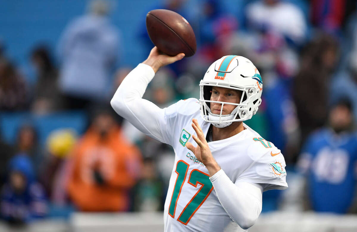 FILE - In this Dec. 30, 2018, file photo, Miami Dolphins quarterback Ryan Tannehill warms-up before an NFL football game against the Buffalo Bills, in Orchard Park, N.Y. Tannehill has been traded to the Tennessee Titans in a deal that also involves draft picks. Tannehill’s departure from Miami had been expected. He became the Dolphins’ starting quarterback as a rookie in 2012 and has still never taken a postseason snap. (AP Photo/Adrian Kraus)