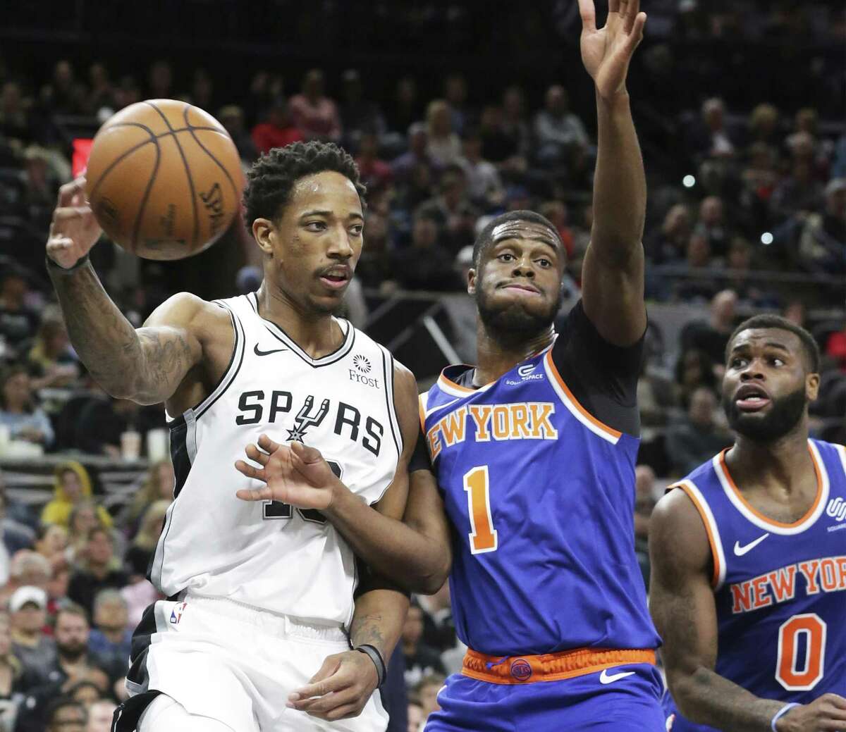 DeMar DeRozan passes out from the paint past Emmanuel Mudiay as the Spurs host the Knicks at the AT&T Center on March 15, 2019.