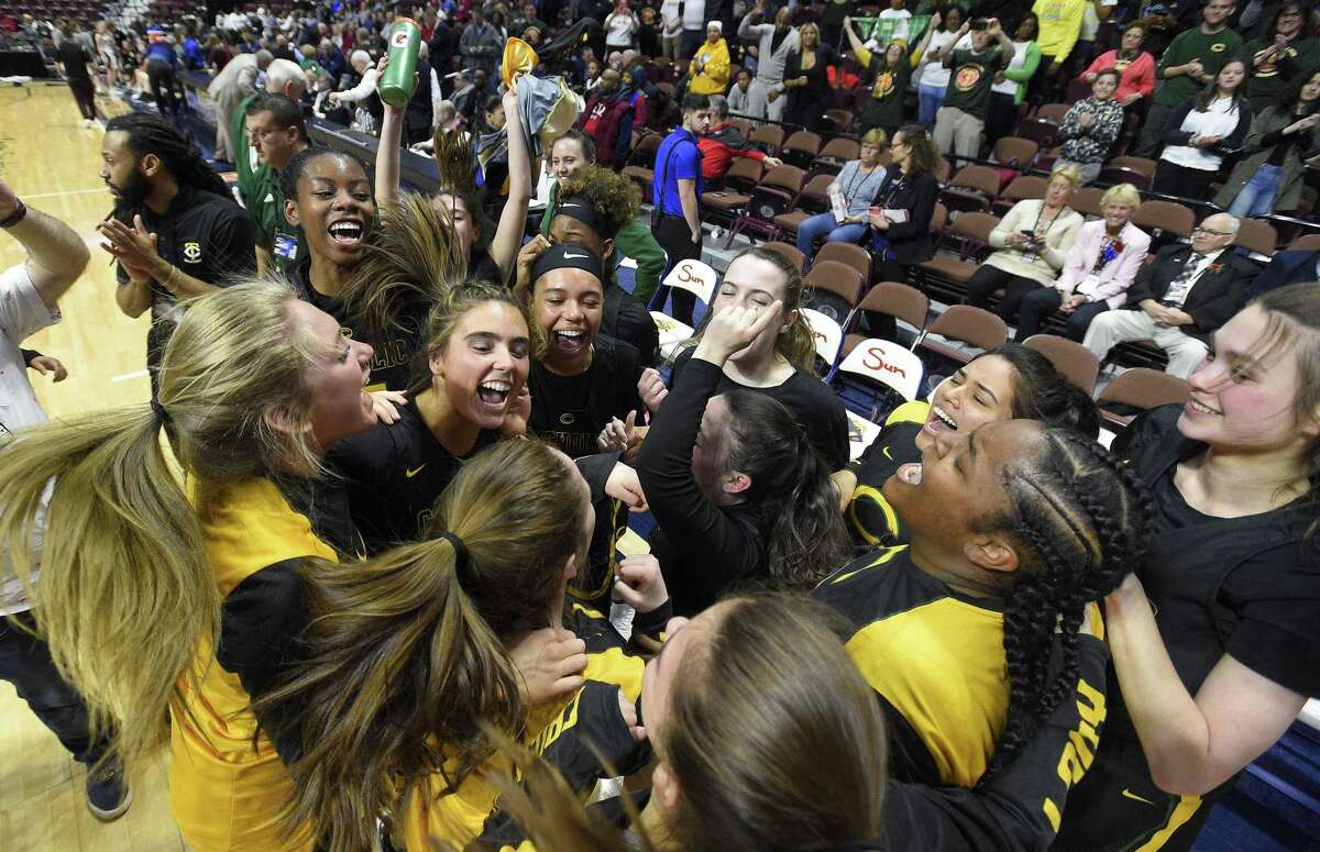 Trinity Catholic celebrates their 52-45 win over Canton in the CIAC 2019 State Girls Basketball Tournament Class S Finals at the Mohegan Sun Arena in Uncasville, Conn. on Saturday, March 16, 2019.