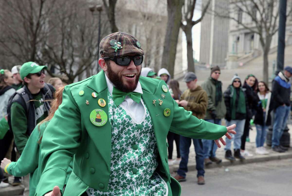 The happy revelry of St. Patrick's Day will be muted in Albany Saturday. The city canceled Saturday's St. Patrick's Day parade after two people in Albany County were diagnosed with COVID-19. Gary Robusto waves and dances with parade goers during the 69th Annual Albany St. Patrick's Day Parade on Saturday, March 16, 2019 in Albany, NY. (Phoebe Sheehan/Times Union)