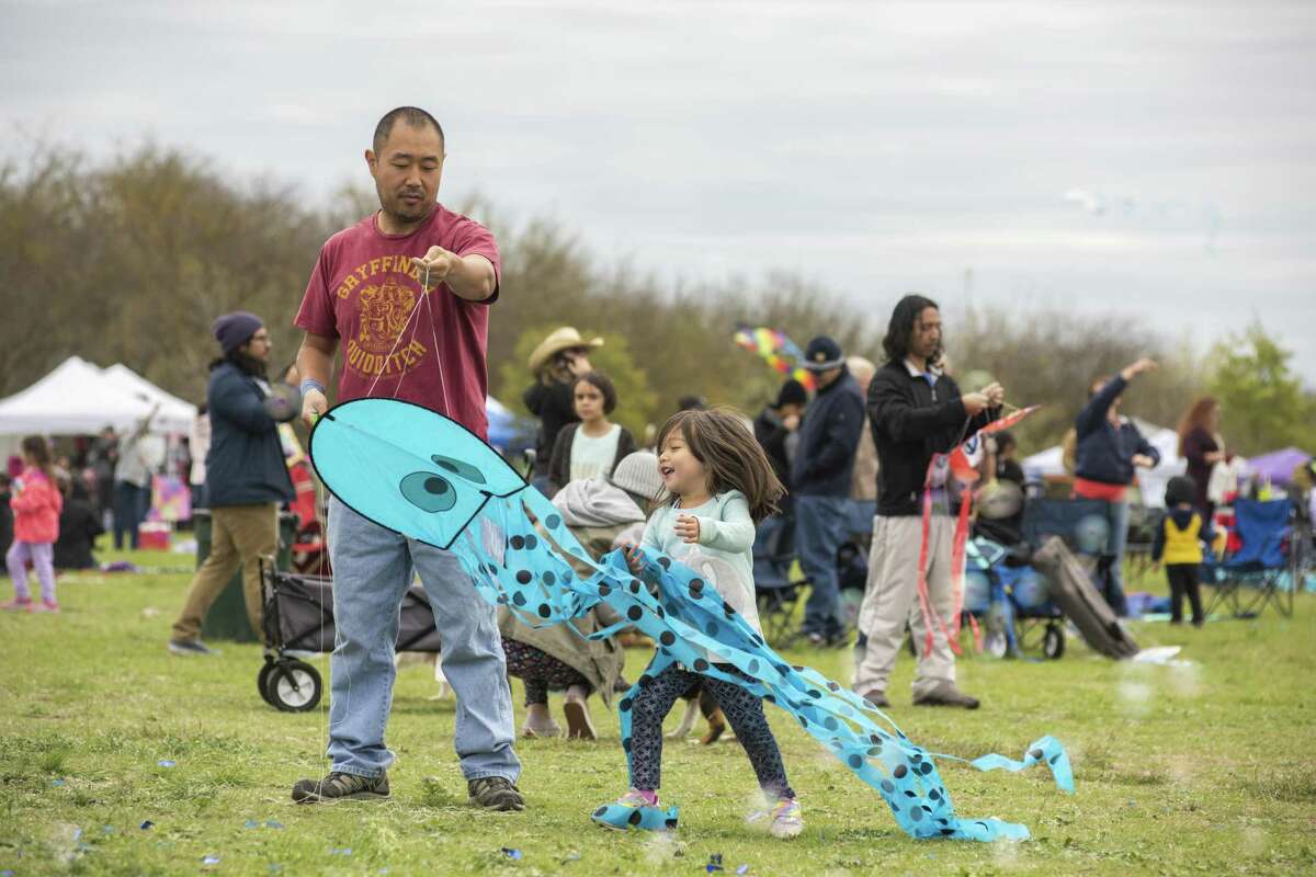 Zoe Barron Eshleman, 4, chases a kit as her dad Peter pulls on the strings during the Fest of Tails at McAllister Park on Saturday, March 16th, 2019. In years past is is estimated that 8,000 people from all over the Central-Texas region have attended the festival.