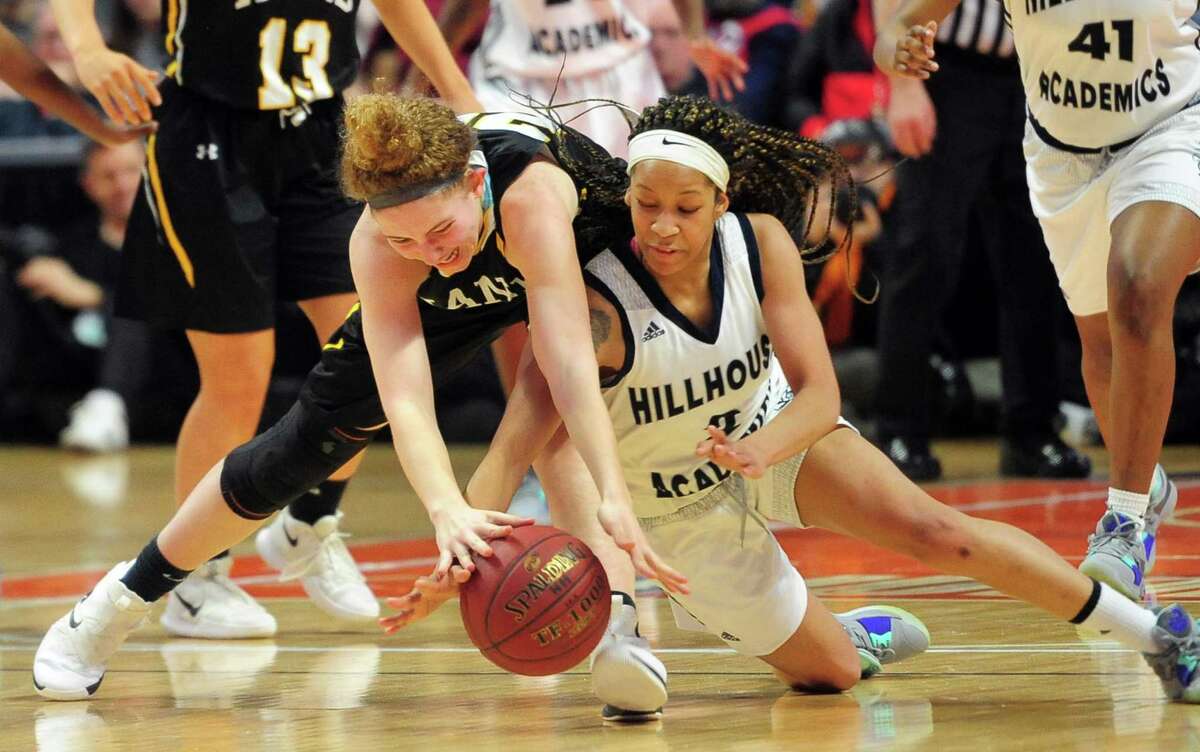 Daniel Hand’s Summer Adamds (20), left, and Hillhouse’s Ciara Little (2) reach for a loose ball during Class L girls basketball championship action in Uncasville, Conn., on Saturday Mar. 16, 2019.